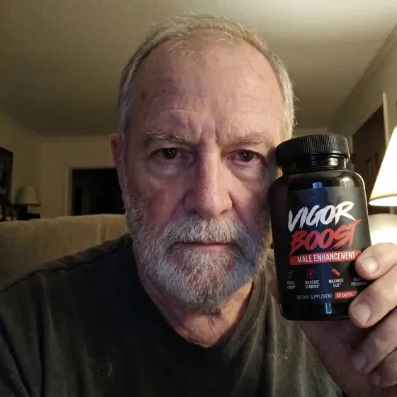 A VigorBoost&reg; customer holding the bottle