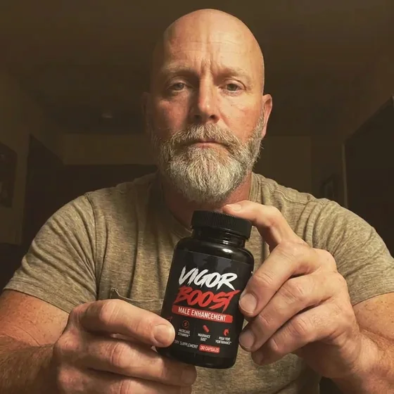 A VigorBoost&reg; customer holding the bottle