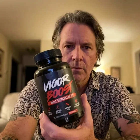 A VigorBoost&reg; customer holding the bottle