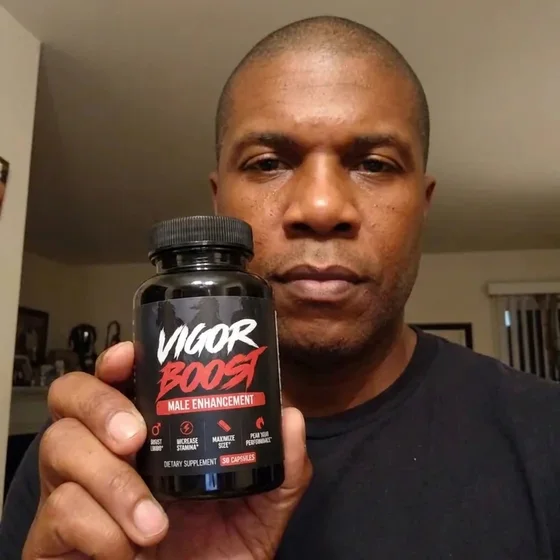 A VigorBoost&reg; customer holding the bottle